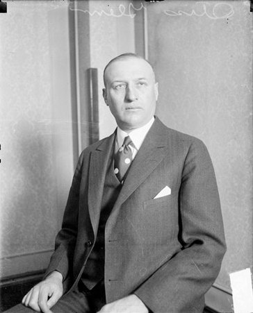 Otis F. Glenn looking up and to the right, sitting in a room - Chicago Daily News, Inc.