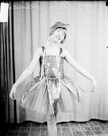 Mary Ellen Spelman wearing a dance costume, posing in a room - Chicago Daily News, Inc.