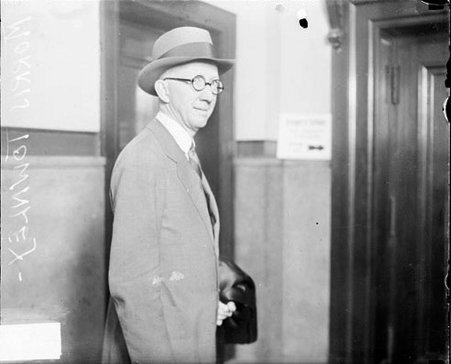 Morris Townley looking toward the camera, standing in a room - Chicago Daily News, Inc.