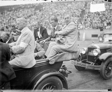 Charles A. Lindbergh sitting with William Hale Thompson in the back of an automobile driving on the field at Soldier Field - Chicago Daily News, Inc.