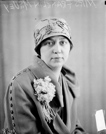 Mrs. Franklin McVey looking toward the camera, sitting in front of a backdrop in a room - Chicago Daily News, Inc.