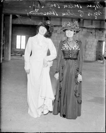 Ellen Henrotin and an unidentified woman wearing costumes standing in a room - Chicago Daily News, Inc.