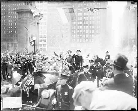 Bremen Flyers sitting and waving in the back seat of an automobile during a parade, looking west on Monroe Street - Chicago Daily News, Inc.