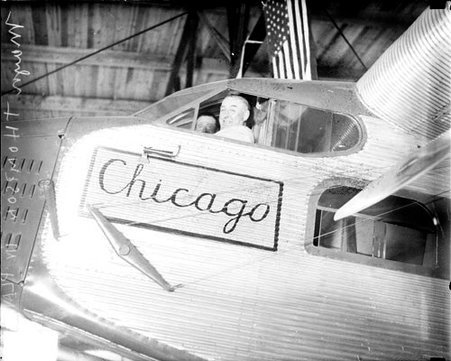 Mayor William Hale Thompson sitting in the cockpit of an airplane in an airplane hanger - Chicago Daily News, Inc.