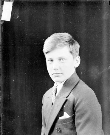 Middle son of Walter Strong looking to the right of the camera, sitting in a room - Chicago Daily News, Inc.