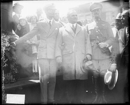 Bremen Flyers standing next to a memorial amid a crowd - Chicago Daily News, Inc.