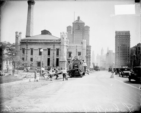 Old Chicago Water Tower with workers and tractors in foreground - Chicago Daily News, Inc.