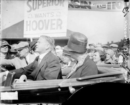 Mr. and Mrs. Herbert Hoover sitting in the back seat of a convertible automobile - Chicago Daily News, Inc.