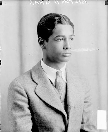 Milton Gray facing to the right of the camera, sitting in a room - Chicago Daily News, Inc.