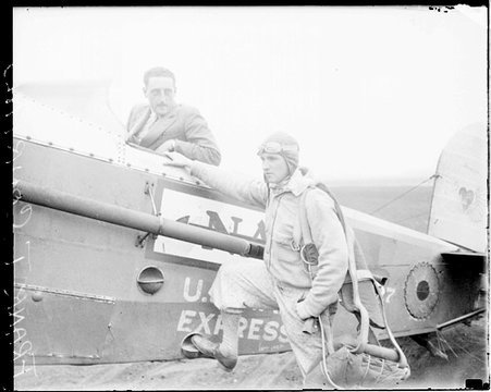 Captain Frank T. Courtney standing next to a U.S. Mail Express airplane - Chicago Daily News, Inc.