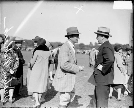 Horseman Austin Niblack and another man, standing and talking - Chicago Daily News, Inc.