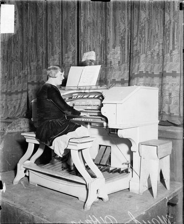 Maud O'Hara, organist, sitting in profile - Chicago Daily News, Inc.