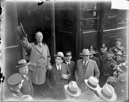 Governor Alfred Smith of New York during his presidential campaign, standing on steps of a train car in Chicago - Chicago Daily News, Inc.