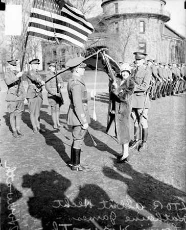 Katherine James, Albert Hecht and Louis Horwath standing on a field with a group of soldiers - Chicago Daily News, Inc.