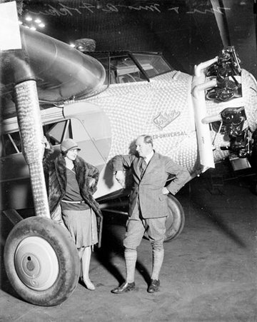 Mr. and Mrs. Anthony Fokker standing in front of a Fokker airplane in a hangar - Chicago Daily News, Inc.