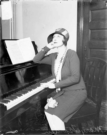 Miss Mary Garden at piano - Chicago Daily News, Inc.