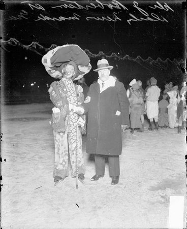 Chicago Daily News ice carnival with Dr. J. Robertson and a man wearing a ice skates and a clown costume - Chicago Daily News, Inc.