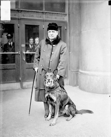 Sen. Thomas D. Schall with dog, looking left - Chicago Daily News, Inc.