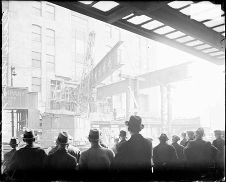 Chicago Daily News building with construction cranes lifting beams - Chicago Daily News, Inc.
