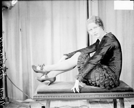 Viola Jorgenson, sitting with her feet on a bench - Chicago Daily News, Inc.