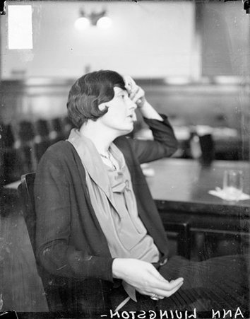Ann Livingston, who sued millionaire Franklin S. Hardinge for breach of promise, holding her left hand to her forehead, sitting in profile at a table in a courtroom - Chicago Daily News, Inc.