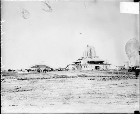 Crowds standing in front of two buildings at Sky Harbor Airport in Glencoe, Illinois - Chicago Daily News, Inc.