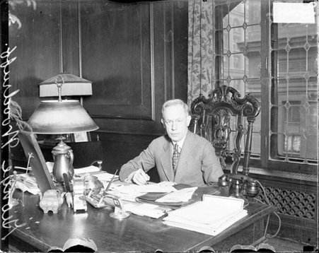 George Woodruff, holding piece of paper, light exposure - Chicago Daily News, Inc.