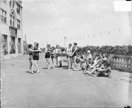 Girls in bathing suits and holding hands at Edgewater Athletic Club - Chicago Daily News, Inc.