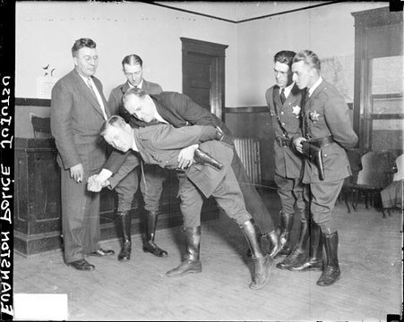 Officer Edgar Fellows of the Evanston, Illinois, Police Department, demonstrating a jujitsu maneuver - Chicago Daily News, Inc.