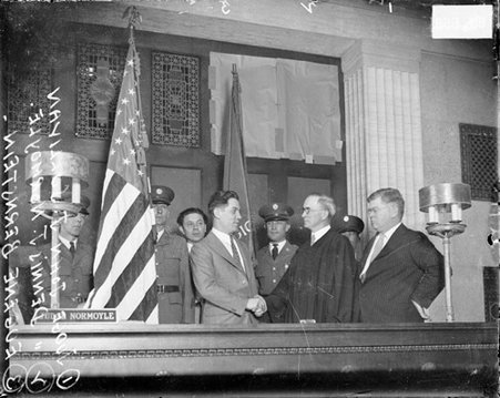 Eugene Bernstein and Dennis J. Normoyle shaking hands in a courtroom - Chicago Daily News, Inc.