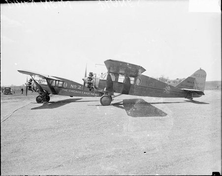 Two Chicago Daily News airplanes sitting on an airfield, viewed in profile - Chicago Daily News, Inc.