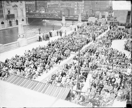 Crowds sitting in the plaza of the new Chicago Daily News Building during a dedication ceremony, light exposure - Chicago Daily News, Inc.