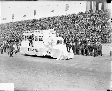 Automobile decorated as a float driving on a track surrounding the field at Soldier Field - Chicago Daily News, Inc.
