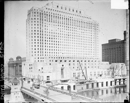 New Chicago Daily News building, nearing completion, and automobiles are driving on a bridge - Chicago Daily News, Inc.