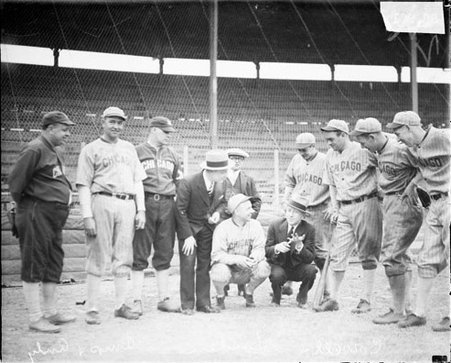 Actors Charlie J. Correll and Freeman Gosden of the WMAQ radio program Amos 'n Andy, posing with eight members of a Chicago baseball team on a field at a baseball stadium - Chicago Daily News, Inc.