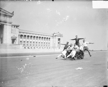 Eight police officers posing on motorcycles on a street in front of the Field Museum of Natural History, dark exposure - Chicago Daily News, Inc.
