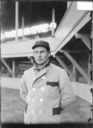Baseball player, Mike Kahoe, St. Louis Browns, standing near grandstand concourse, South Side Park - Chicago Daily News, Inc.