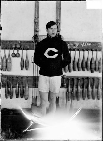 Athlete, Blair, University of Chicago, standing in front of weight training equipment in a gymnasium - Chicago Daily News, Inc.