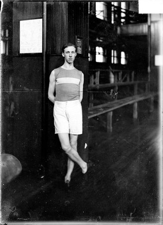 Athlete, L. Clapper, standing in a gymnasium - Chicago Daily News, Inc.