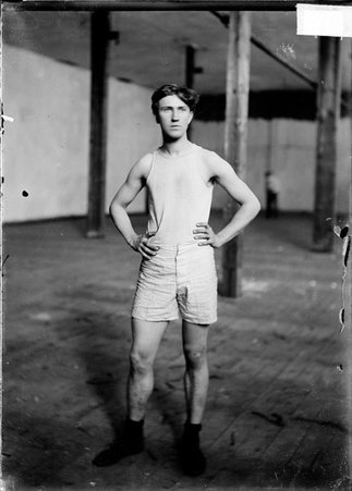 Athlete, Meffard, standing in empty room - Chicago Daily News, Inc.