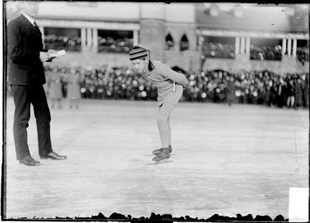 Speed skater, Halverson, in skating posture, with race official, on the frozen lagoon in Humboldt Park - Chicago Daily News, Inc.