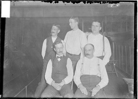 Bowling team, unidentified, five members, man standing in center is looking to his right, posing in a bowling alley - Chicago Daily News, Inc.