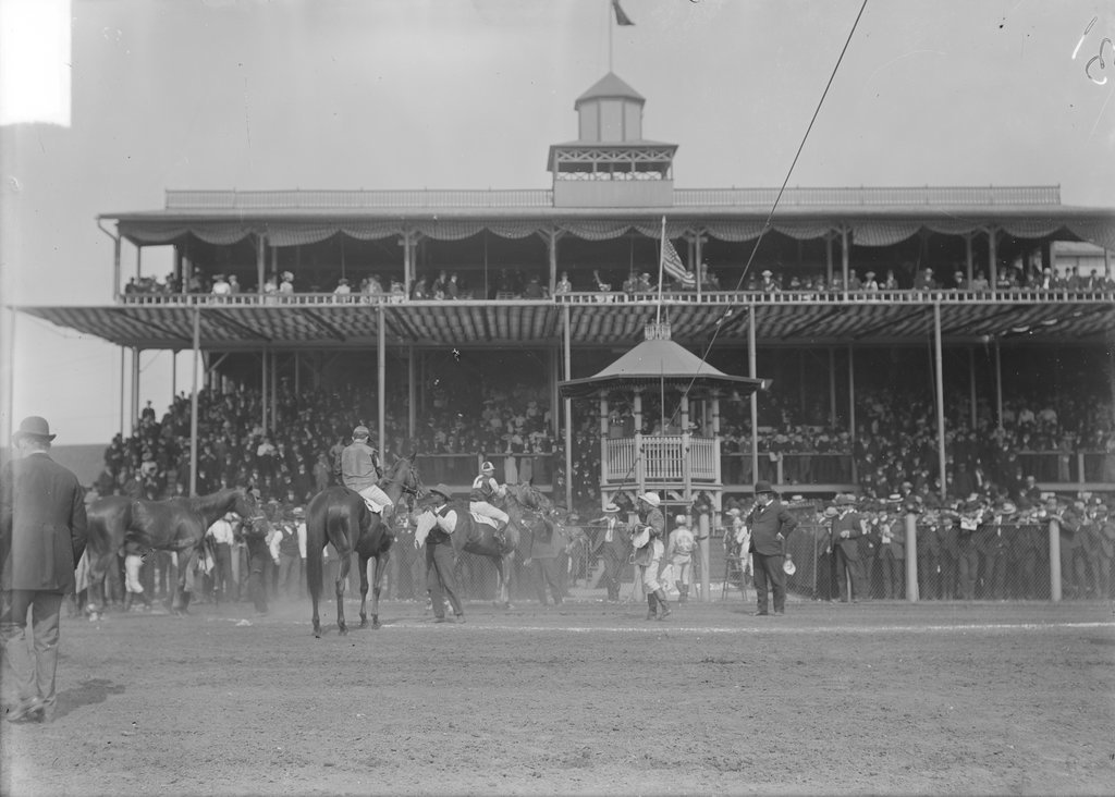Hawthorne Race Track, group of racehorses, jockeys, and handlers in front of grandstand filled with spectators - Chicago Daily News, Inc.