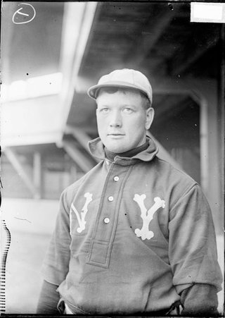 Baseball player, New York Highlanders, standing under bleacher buttresses - Chicago Daily News, Inc.