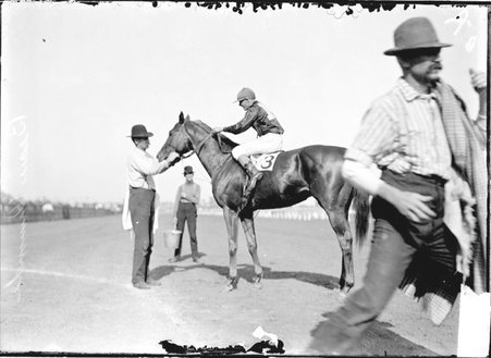 Racehorse, Beau Ormonde, with jockey mounted, standing on track, being attended by handler, Washington Park Race Track - Chicago Daily News, Inc.