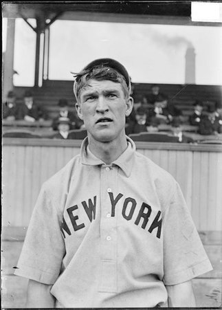 Baseball player, Frank Bowerman, New York Giants, standing on a baseball field near the grandstand - Chicago Daily News, Inc.