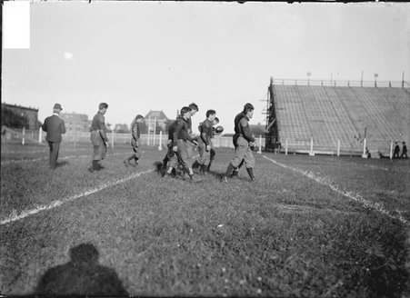 Football game, Northwestern High School-University of Chicago, players walking on field before a play - Chicago Daily News, Inc.