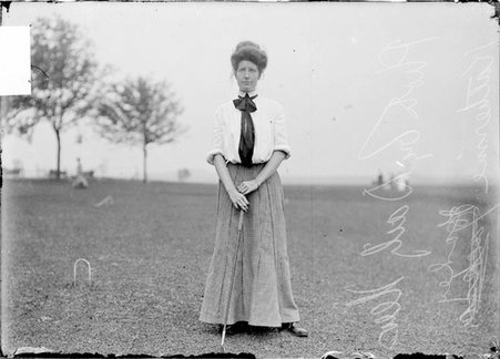 Golfer, Katherine C. Harley, holding a club, standing on the course, Chicago Golf Club - Chicago Daily News, Inc.