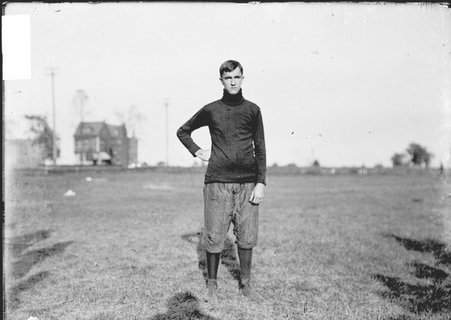 Football player, Lillard, Hyde Park High School, standing on an athletic field - Chicago Daily News, Inc.