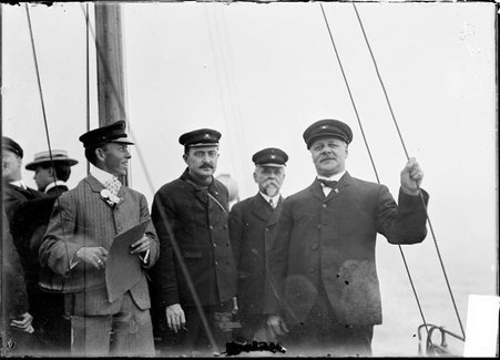 Yachtsmen, W. L. Shephard, W. H. Quinlan, Jas. Ruff, and Fairfax Palmer, standing on yacht deck - Chicago Daily News, Inc.